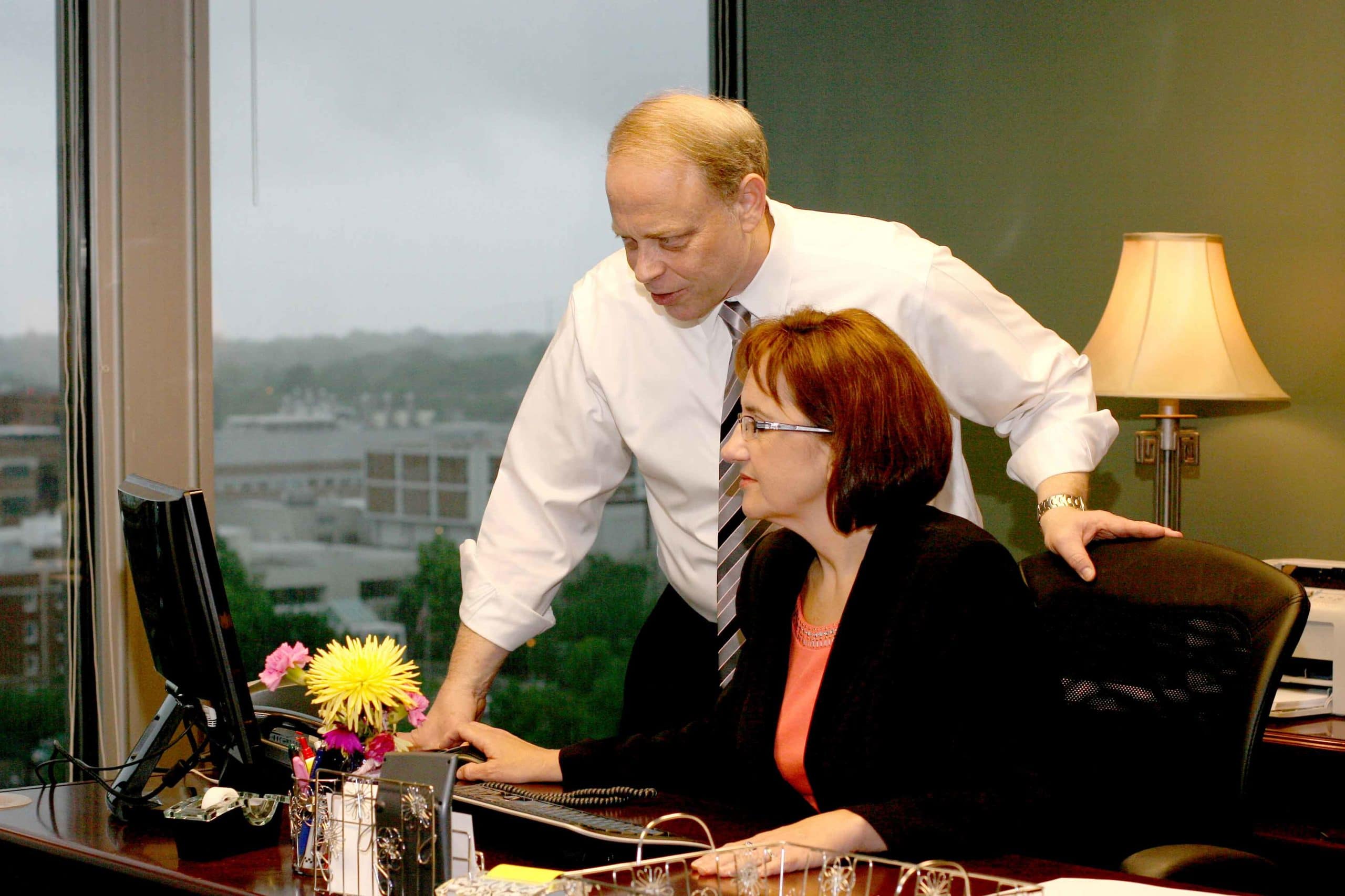 Picture of Kansas City bankruptcy lawyers discussing the pros and cons of debt settlement vs. bankruptcy Photo of Attorneys looking at computer screen